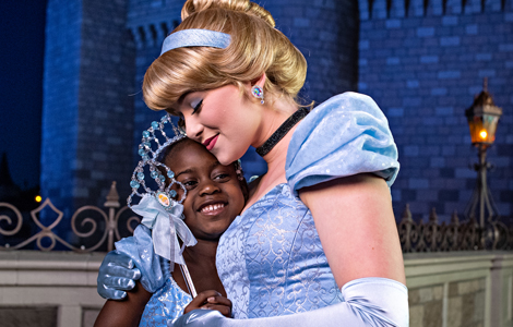Cinderella and a young Guest share a hug